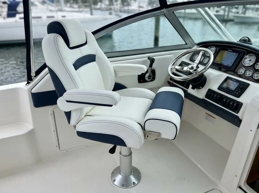 White and navy captain's helm chair at a boat helm